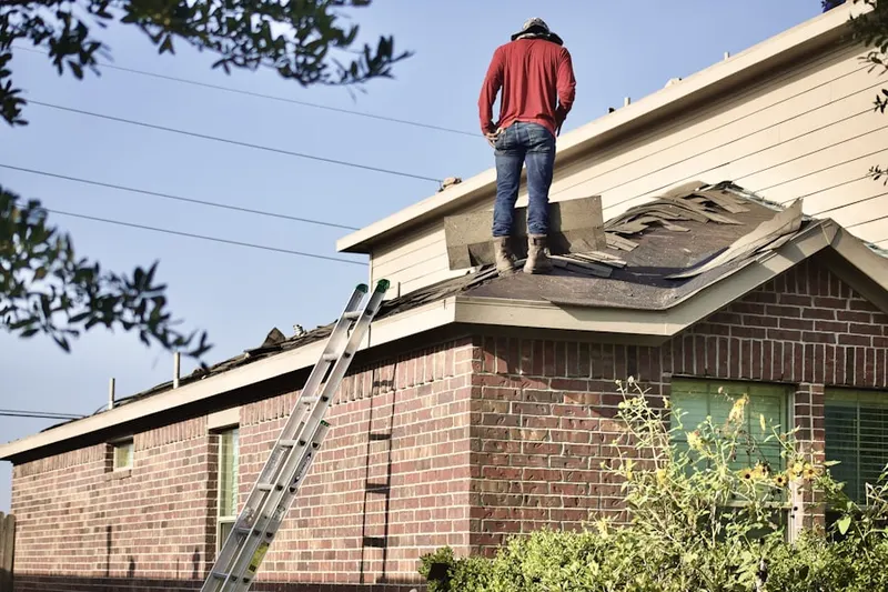 Professional roofer working on a residential roof in Schades Corner